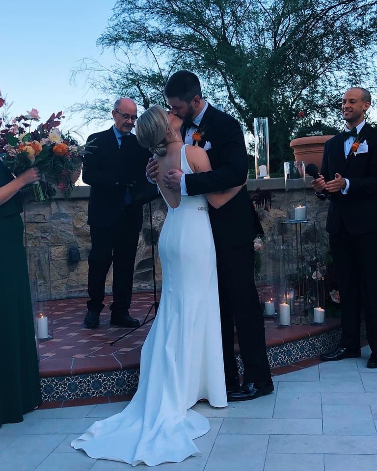 CoSIDA Executive Director Doug Vance instructs nephew Derek it’s time to kiss his bride Dana. Vance presided over the wedding ceremony last month in Phoenix.
